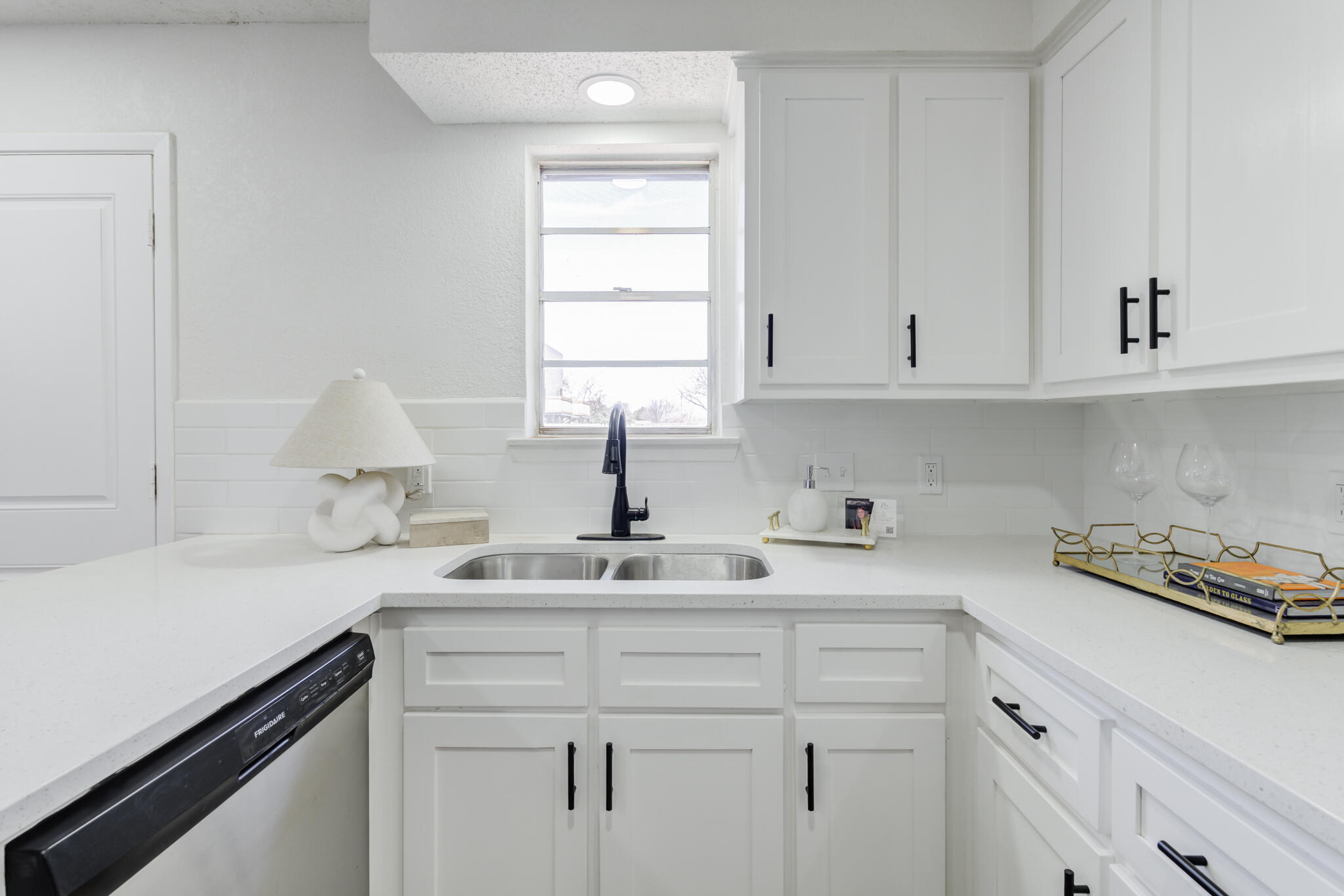 2314 77th Street Lubbock, TX 79423 - Photo 18 of 41 a kitchen with a sink cabinets and window