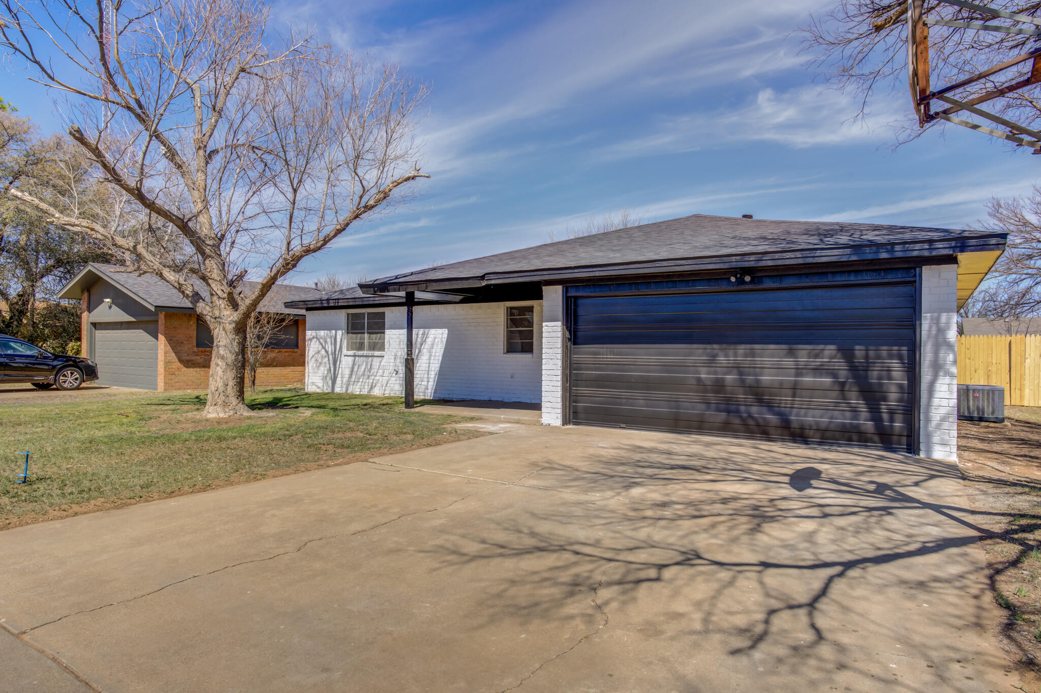 2314 77th Street Lubbock, TX 79423 - Photo 2 of 41 a front view of a house with a yard and garage