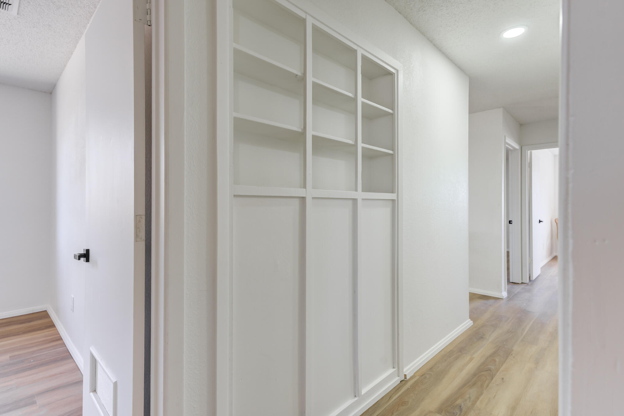 2314 77th Street Lubbock, TX 79423 - Photo 27 of 41 a view of a hallway with wooden floor and closet