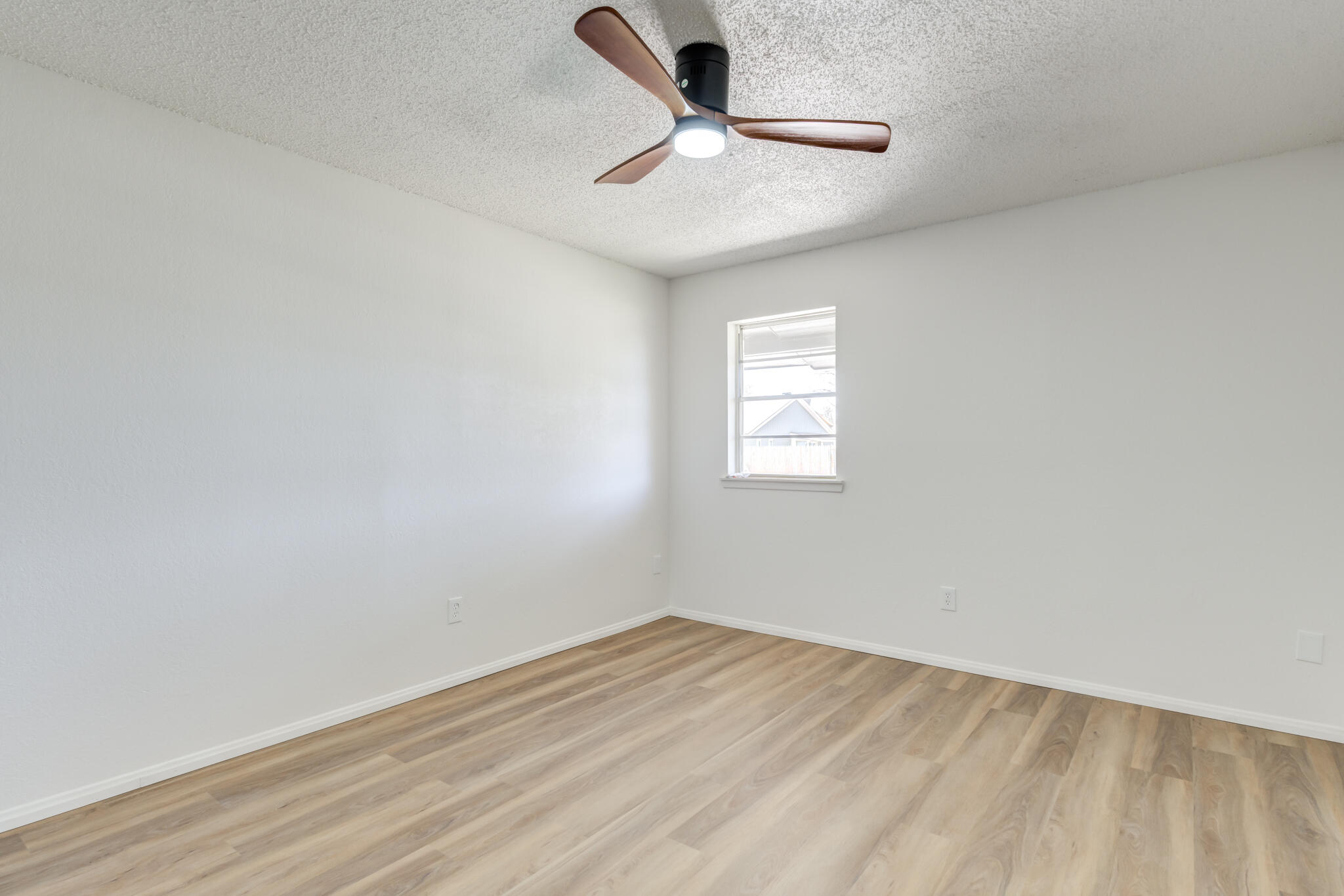 2314 77th Street Lubbock, TX 79423 - Photo 28 of 41 an empty room with a window and a ceiling fan