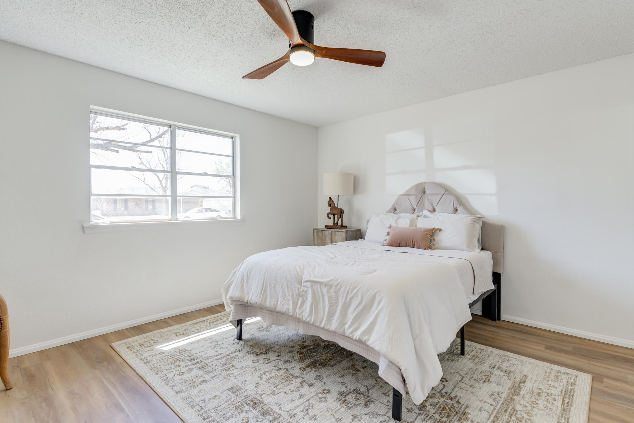 2314 77th Street Lubbock, TX 79423 - Photo 30 of 41 a bedroom with a bed and wooden floor