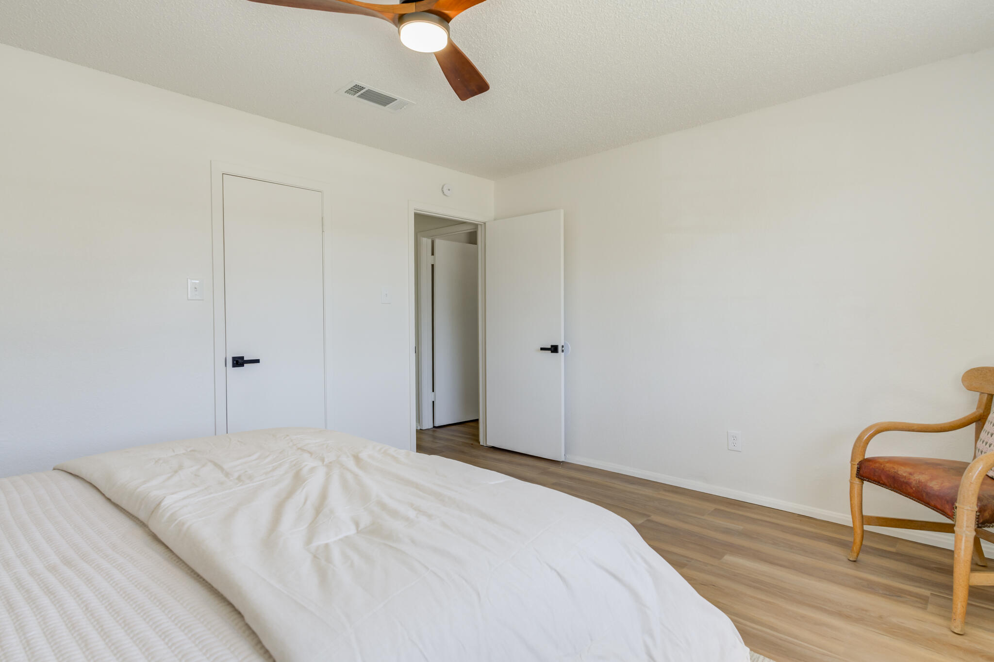 2314 77th Street Lubbock, TX 79423 - Photo 32 of 41 a bedroom with a bed and a chair