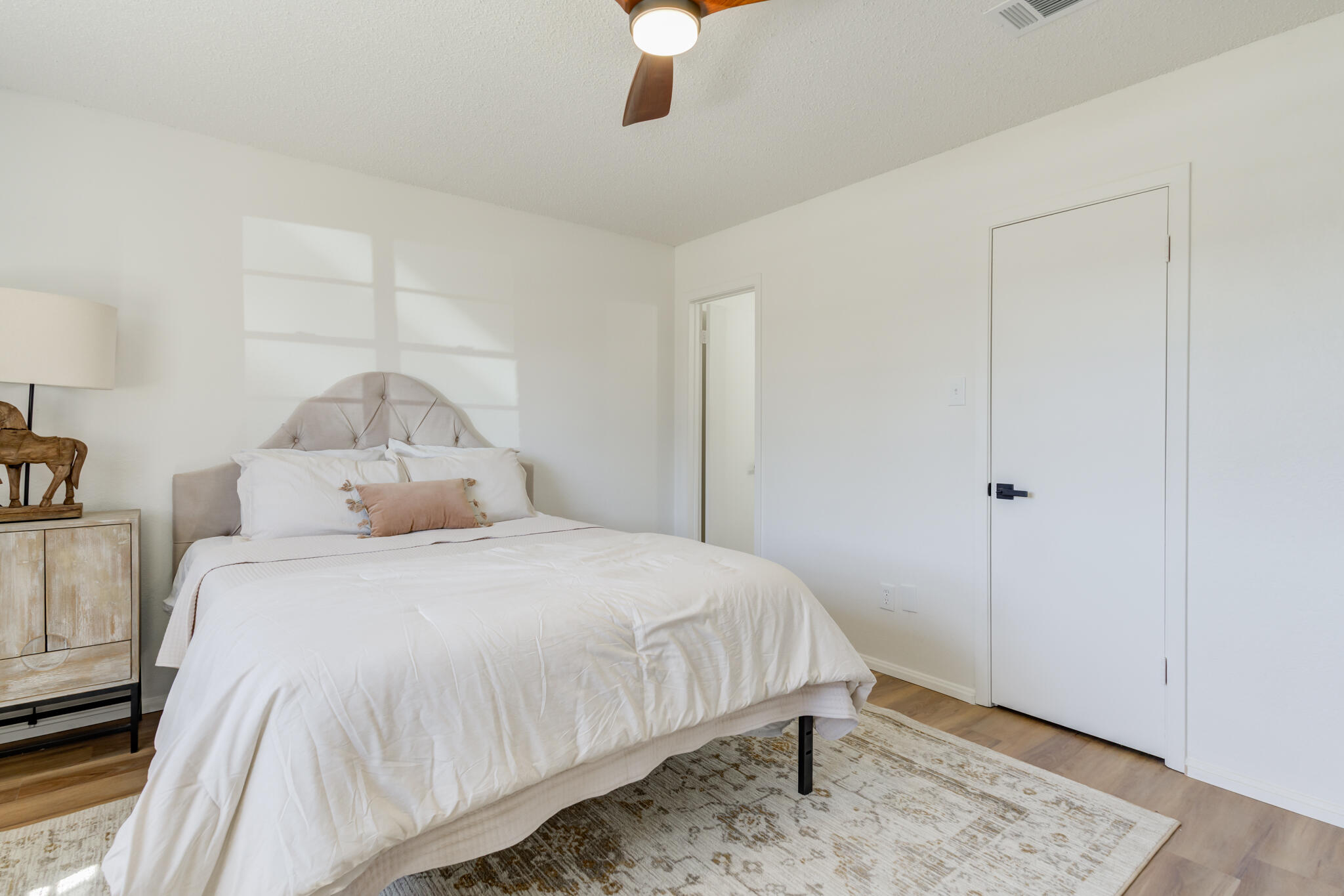 2314 77th Street Lubbock, TX 79423 - Photo 33 of 41 a bedroom with a bed and a potted plant