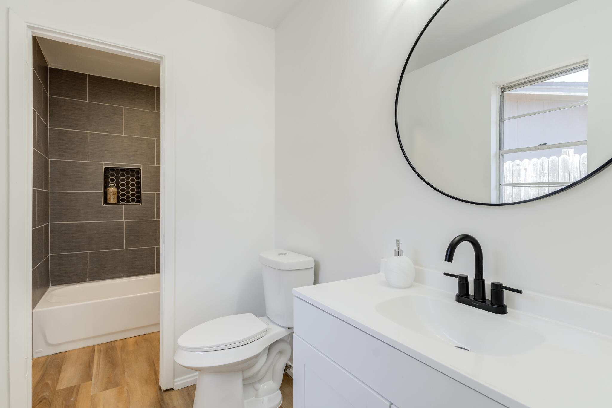 2314 77th Street Lubbock, TX 79423 - Photo 34 of 41 a bathroom with a sink and a mirror