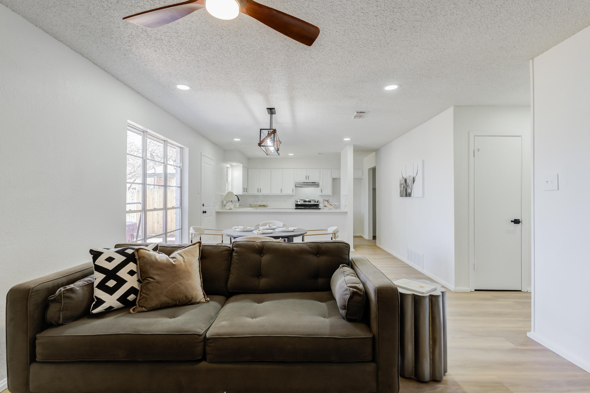 2314 77th Street Lubbock, TX 79423 - Photo 8 of 41 a living room with furniture and a chandelier