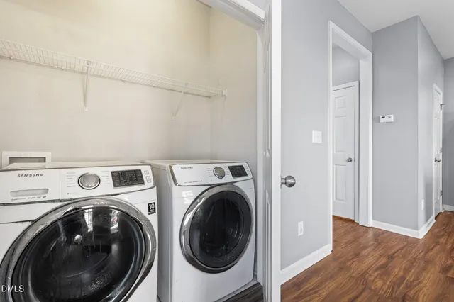 a view of a hallway with washer and dryer