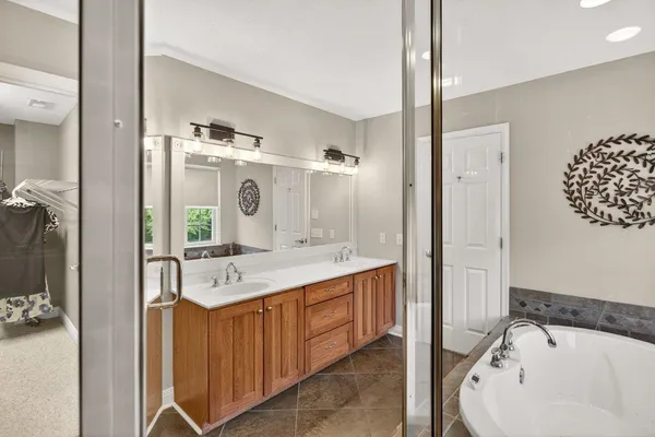 a bathroom with a sink a toilet a mirror and shower curtain