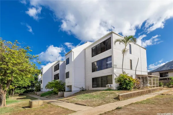 a house with palm tree in front of it