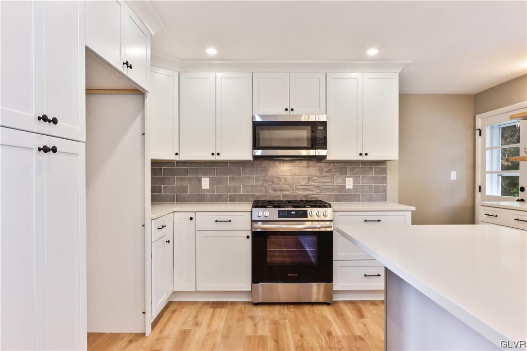 403 Barrett Road Emmaus, PA 18049 - Photo 12 of 44 a kitchen with stainless steel appliances granite countertop a stove a sink and a microwave