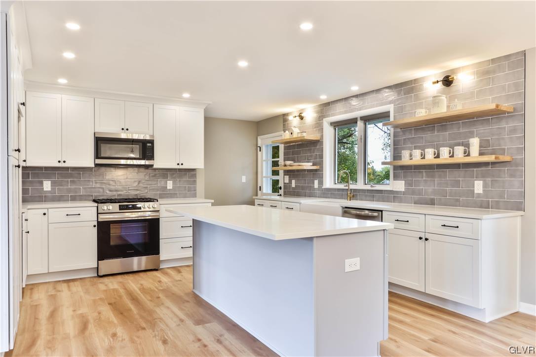 403 Barrett Road Emmaus, PA 18049 - Photo 6 of 44 a kitchen with stainless steel appliances granite countertop a sink stove and refrigerator