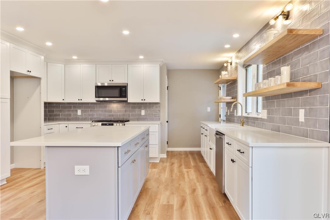 403 Barrett Road Emmaus, PA 18049 - Photo 8 of 44 a kitchen with stainless steel appliances granite countertop a sink stove and refrigerator
