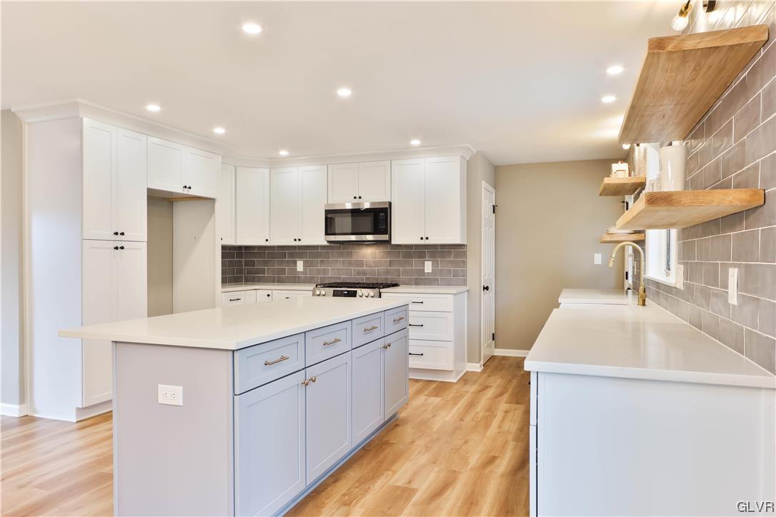 403 Barrett Road Emmaus, PA 18049 - Photo 9 of 44 a kitchen that has a lot of white cabinets and stainless steel appliances