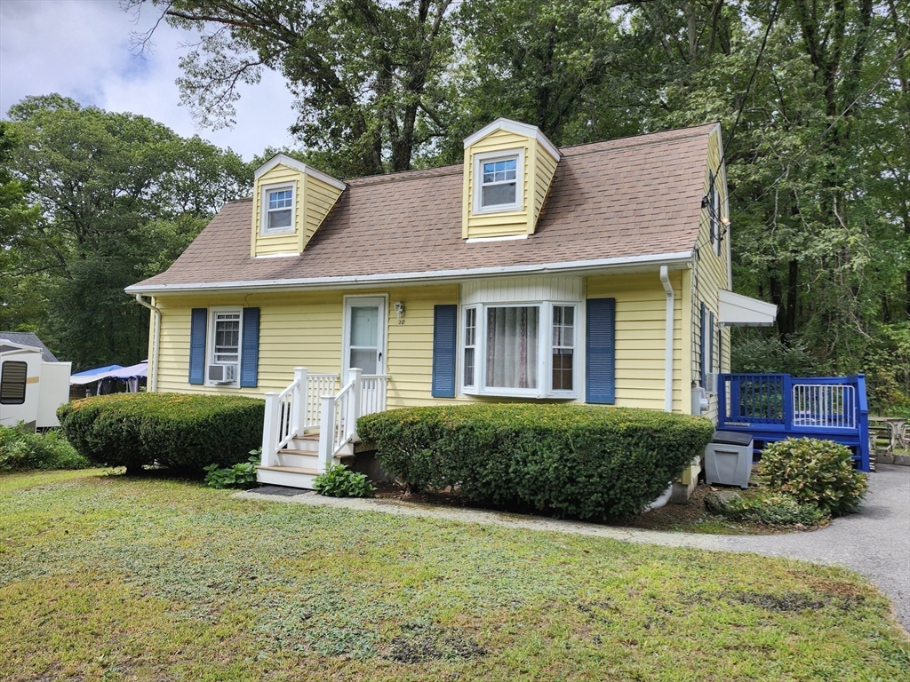 20 Carleton Road Leicester, MA 01542 - Photo 2 of 16 a front view of a house with a garden and plants