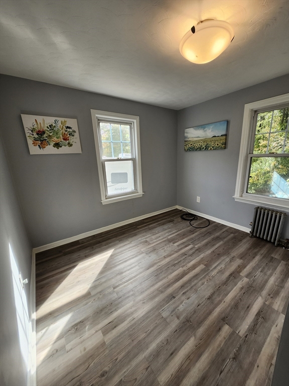 20 Carleton Road Leicester, MA 01542 - Photo 7 of 16 a view of an empty room with wooden floor and a window