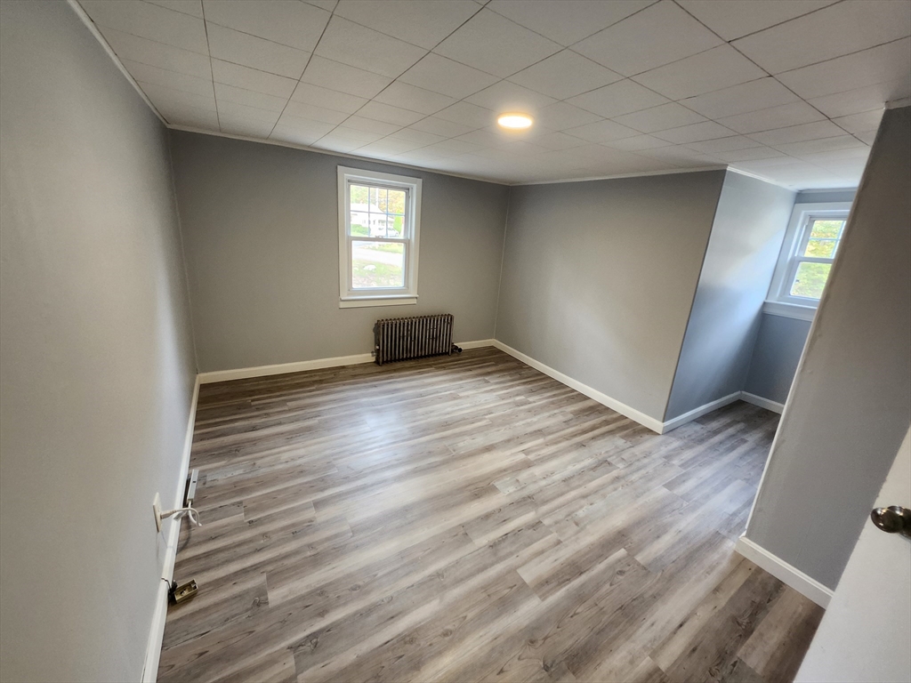 20 Carleton Road Leicester, MA 01542 - Photo 10 of 16 a view of an empty room with wooden floor and a window
