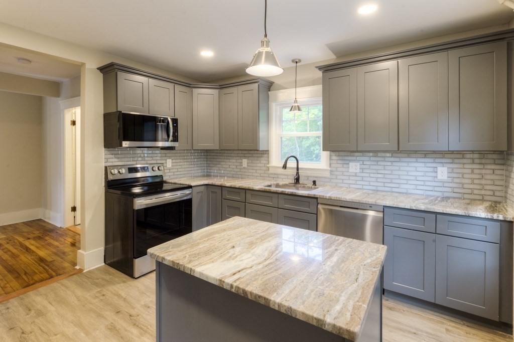 50 Mower Street Worcester, MA 01602 - Photo 13 of 38 a kitchen with a stove a sink and a refrigerator