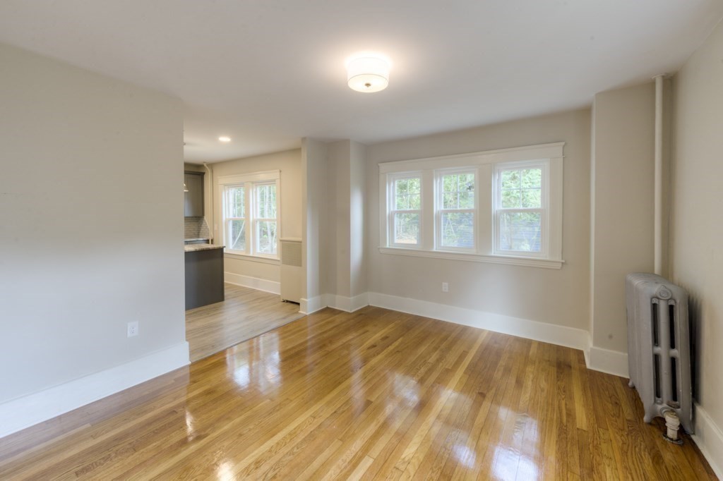 50 Mower Street Worcester, MA 01602 - Photo 16 of 38 an empty room with wooden floor and windows