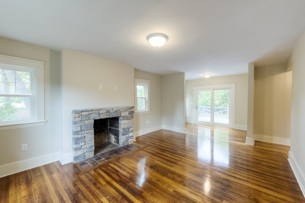 50 Mower Street Worcester, MA 01602 - Photo 3 of 38 a view of empty room with wooden floor and fireplace
