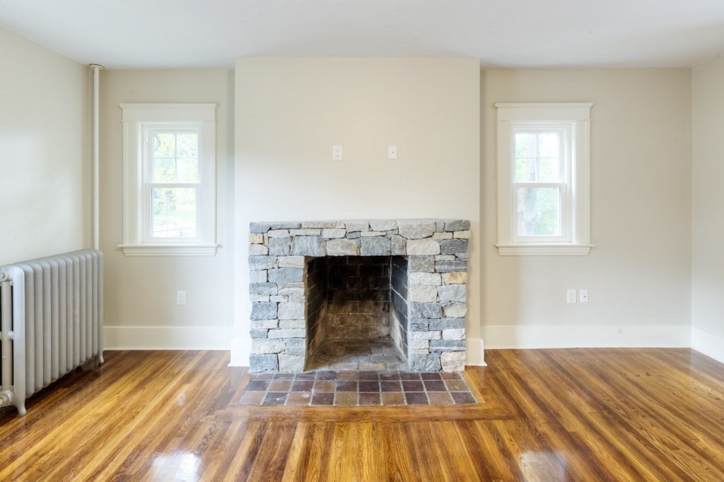 50 Mower Street Worcester, MA 01602 - Photo 5 of 38 a view of a livingroom with wooden floor and a fireplace