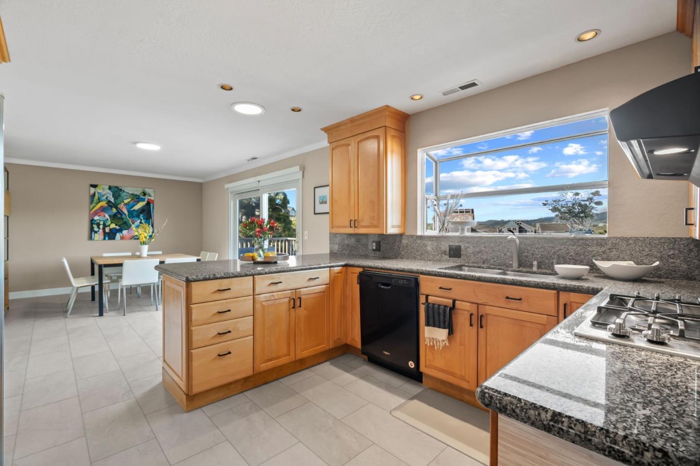 115 Stanley Avenue Pacifica, CA 94044 - Photo 12 of 61 a kitchen with stainless steel appliances granite countertop sink stove and granite counter top
