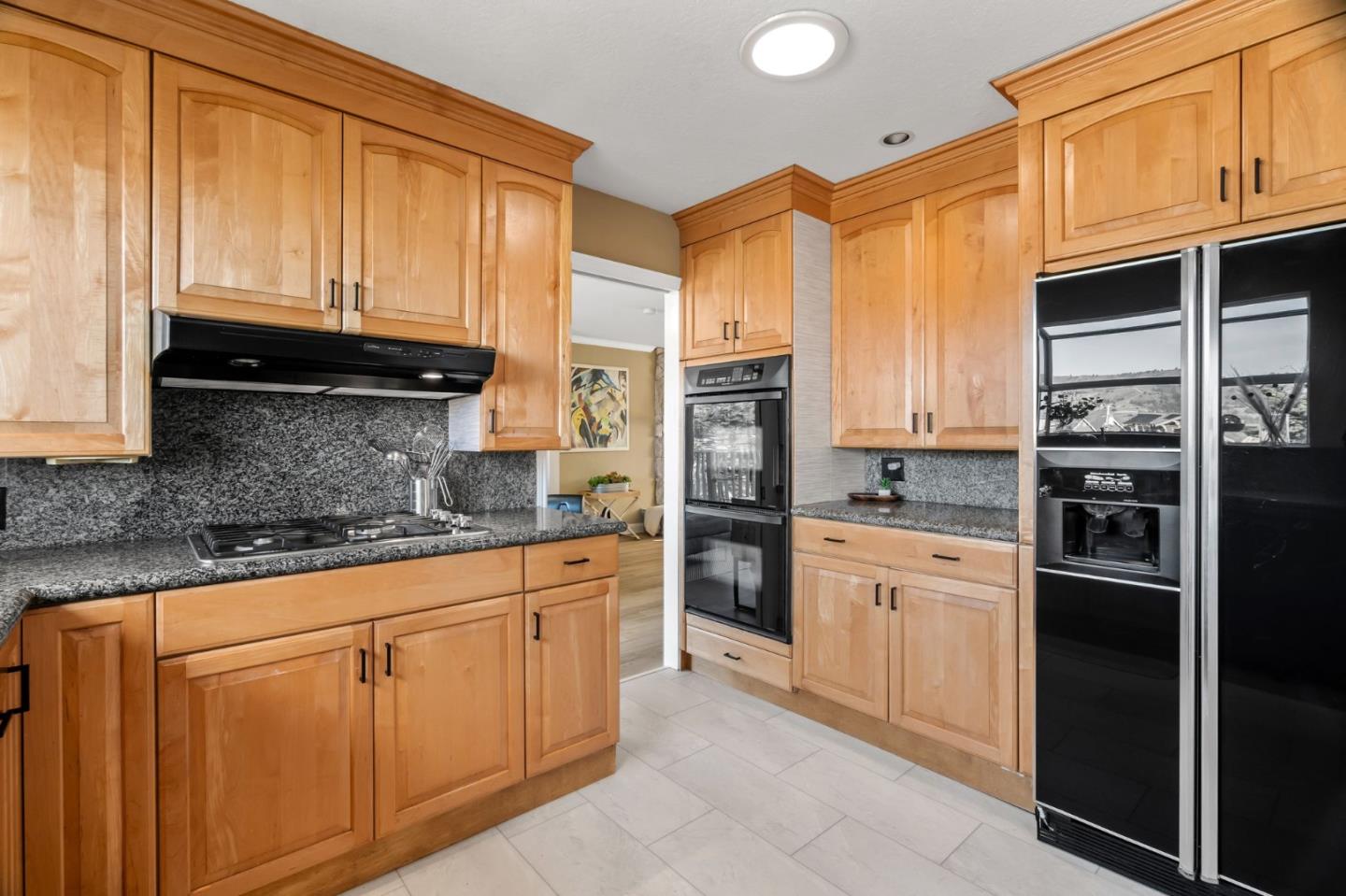 115 Stanley Avenue Pacifica, CA 94044 - Photo 14 of 61 a kitchen with stainless steel appliances granite countertop a refrigerator and cabinets