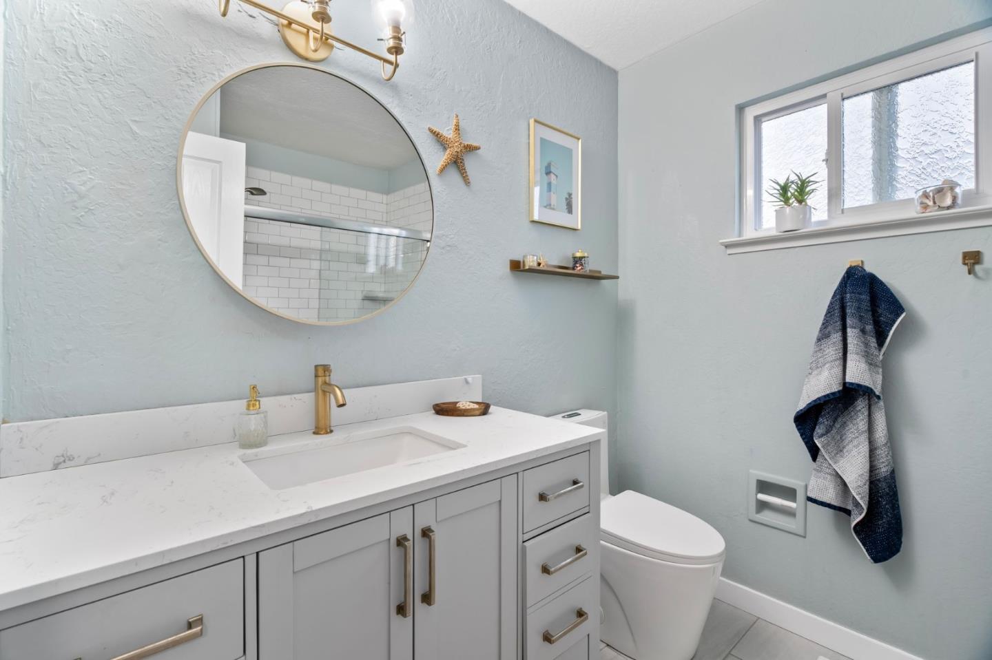 115 Stanley Avenue Pacifica, CA 94044 - Photo 28 of 61 a bathroom with a toilet sink and mirror