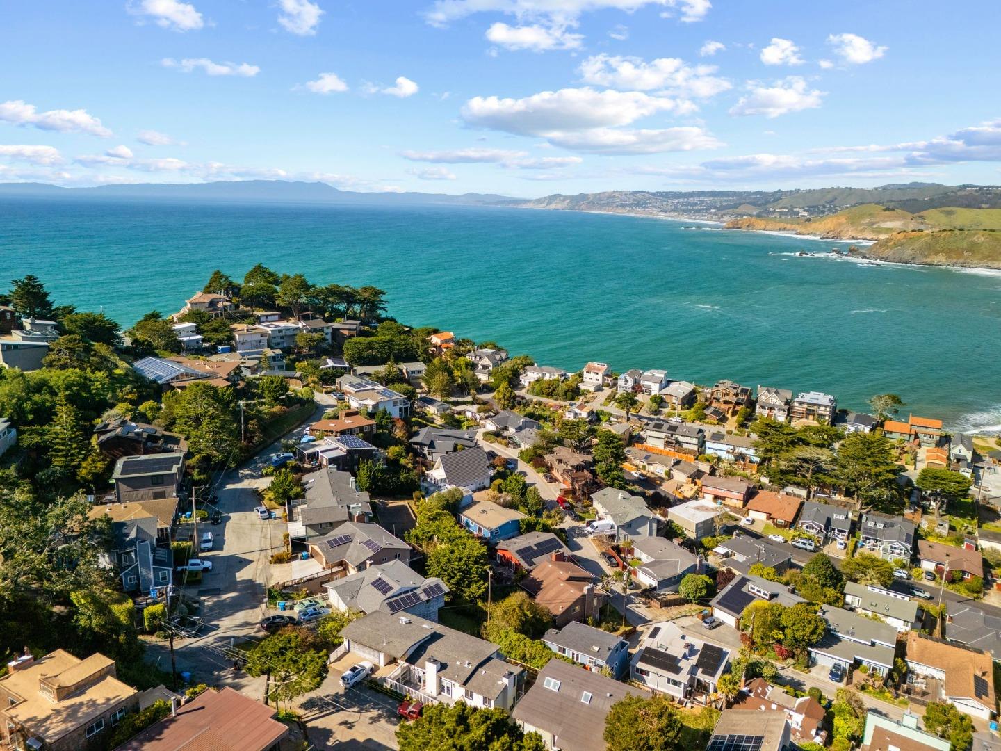 115 Stanley Avenue Pacifica, CA 94044 - Photo 57 of 61 an aerial view of a city with lots of residential buildings and ocean view in back