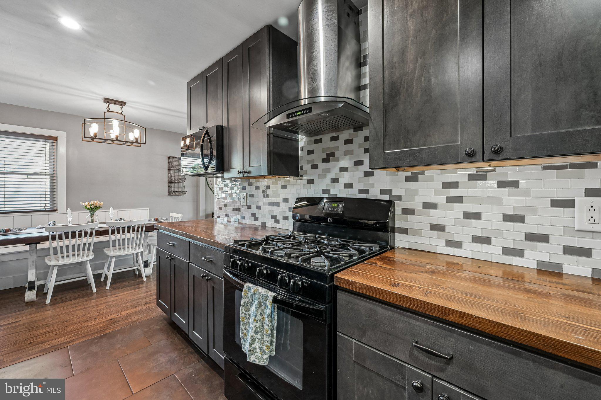 904 Geneva Avenue Delran, NJ 08075 - Photo 12 of 30 a kitchen with stainless steel appliances kitchen island granite countertop a stove a sink and a microwave