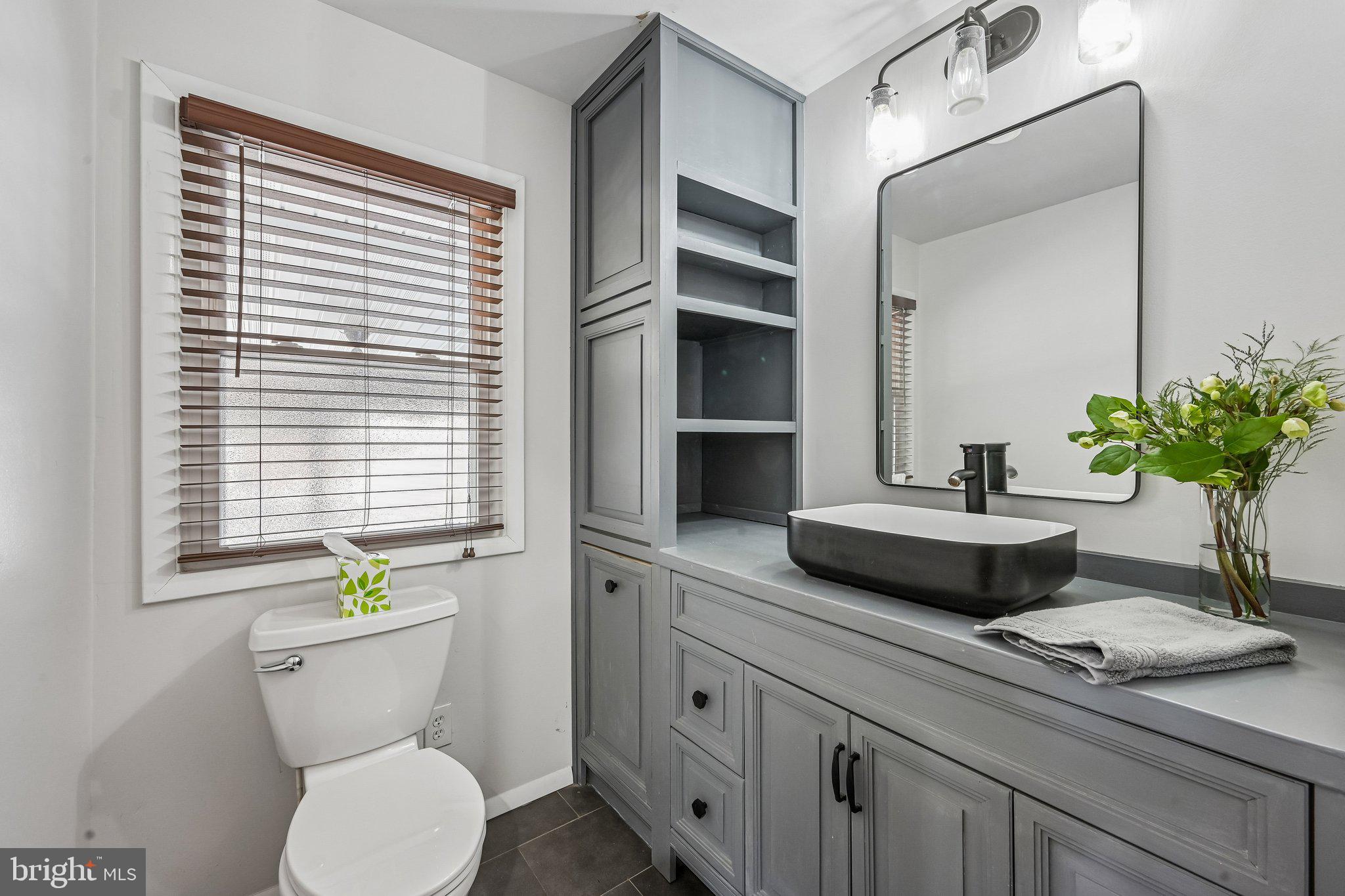 904 Geneva Avenue Delran, NJ 08075 - Photo 16 of 30 a bathroom with a toilet a sink and mirror