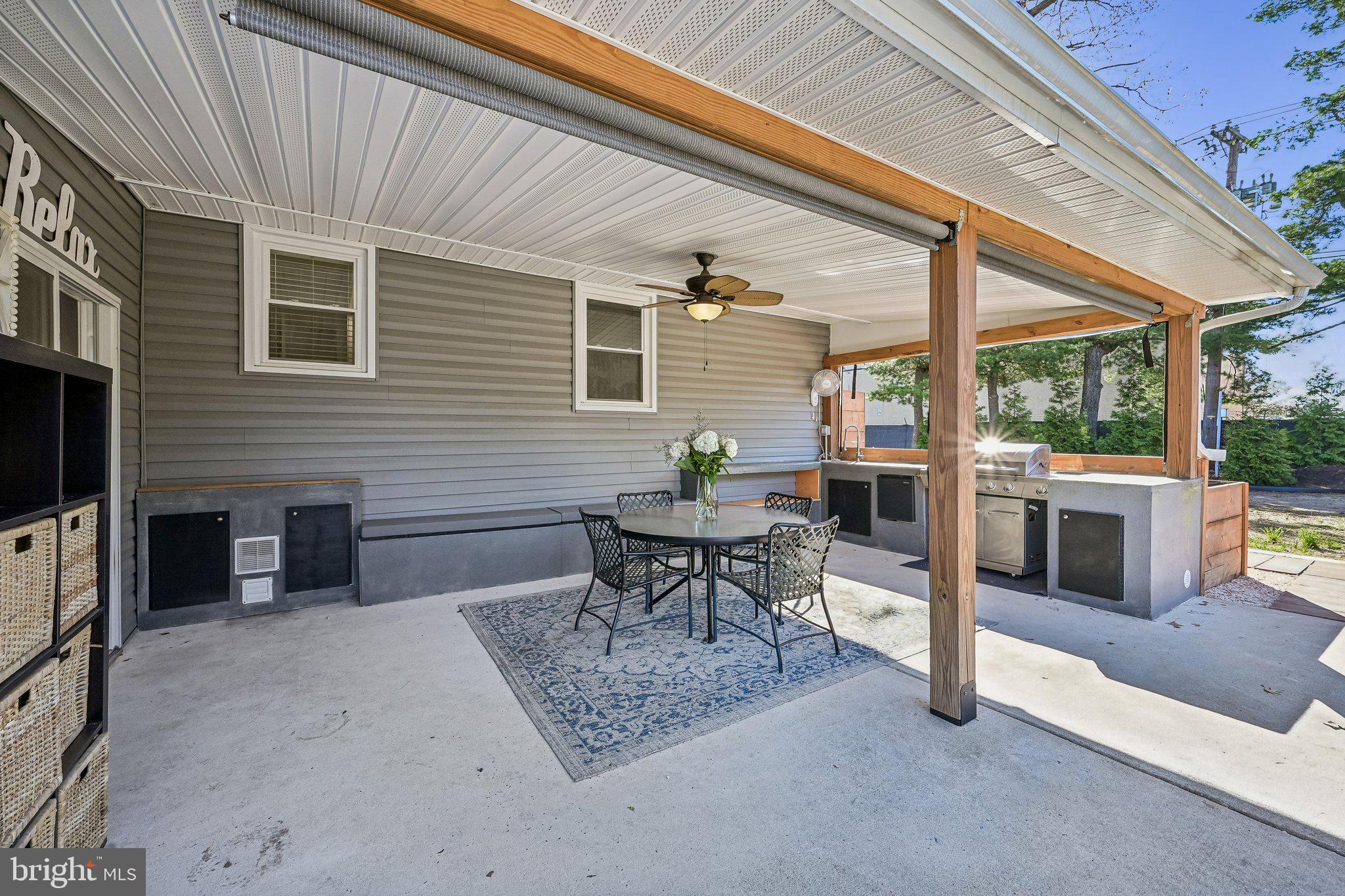 904 Geneva Avenue Delran, NJ 08075 - Photo 24 of 30 a view of a patio with table and chairs with a barbeque grill and a couch