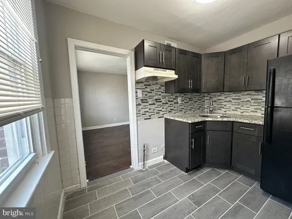 a kitchen with granite countertop a stove and a refrigerator