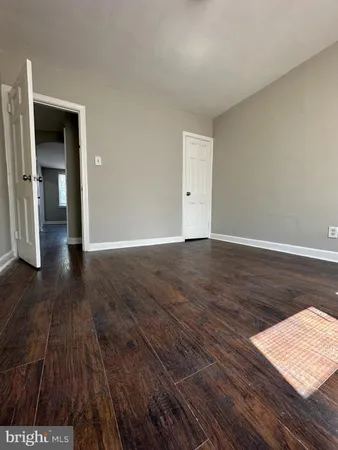 a view of an empty room and wooden floor