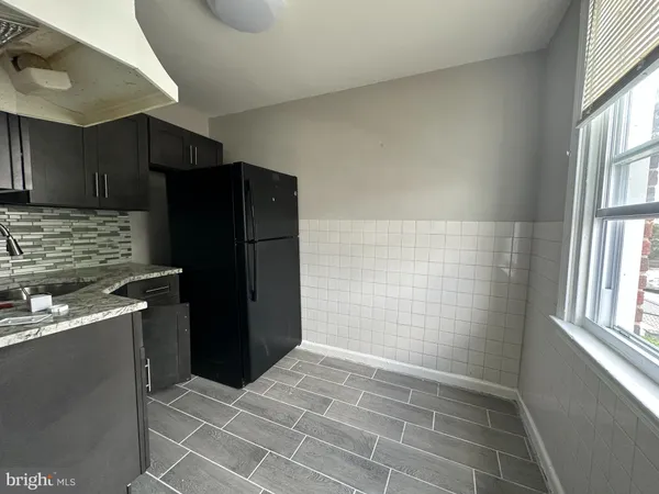 a kitchen with stainless steel appliances a refrigerator and a sink