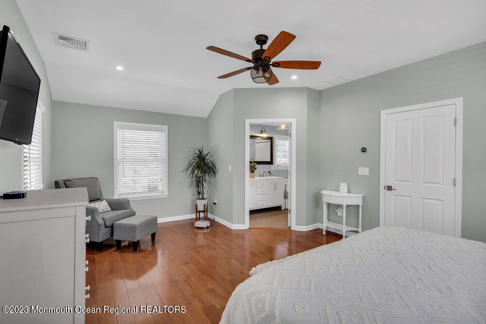 800 Wall Road Spring Lake Heights, NJ 07762 - Photo 21 of 41 a bedroom with a bed and a chandelier