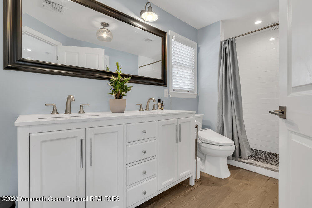 800 Wall Road Spring Lake Heights, NJ 07762 - Photo 22 of 41 a bathroom with a toilet sink and mirror