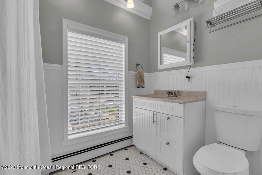 800 Wall Road Spring Lake Heights, NJ 07762 - Photo 28 of 41 a bathroom with a granite countertop toilet a sink a mirror and a window