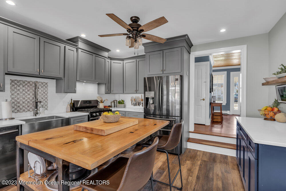 800 Wall Road Spring Lake Heights, NJ 07762 - Photo 4 of 41 a kitchen with stainless steel appliances a table chairs refrigerator and cabinets