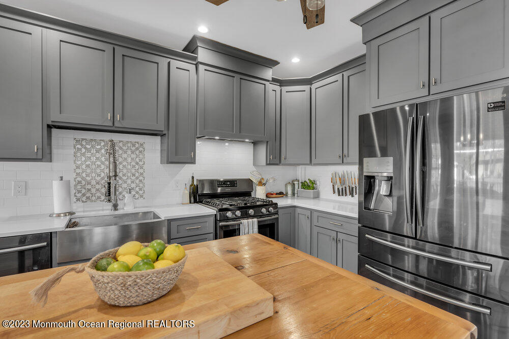 800 Wall Road Spring Lake Heights, NJ 07762 - Photo 5 of 41 a kitchen with stainless steel appliances granite countertop a refrigerator sink and stove