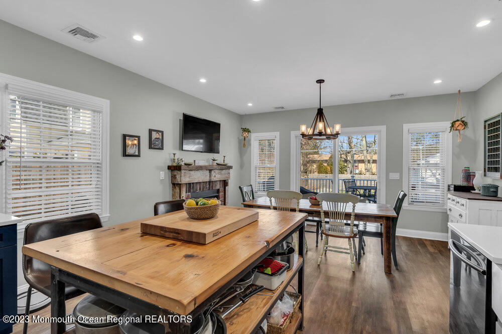 800 Wall Road Spring Lake Heights, NJ 07762 - Photo 7 of 41 a room with stainless steel appliances granite countertop a stove a kitchen island a dining table and chairs with wooden floor