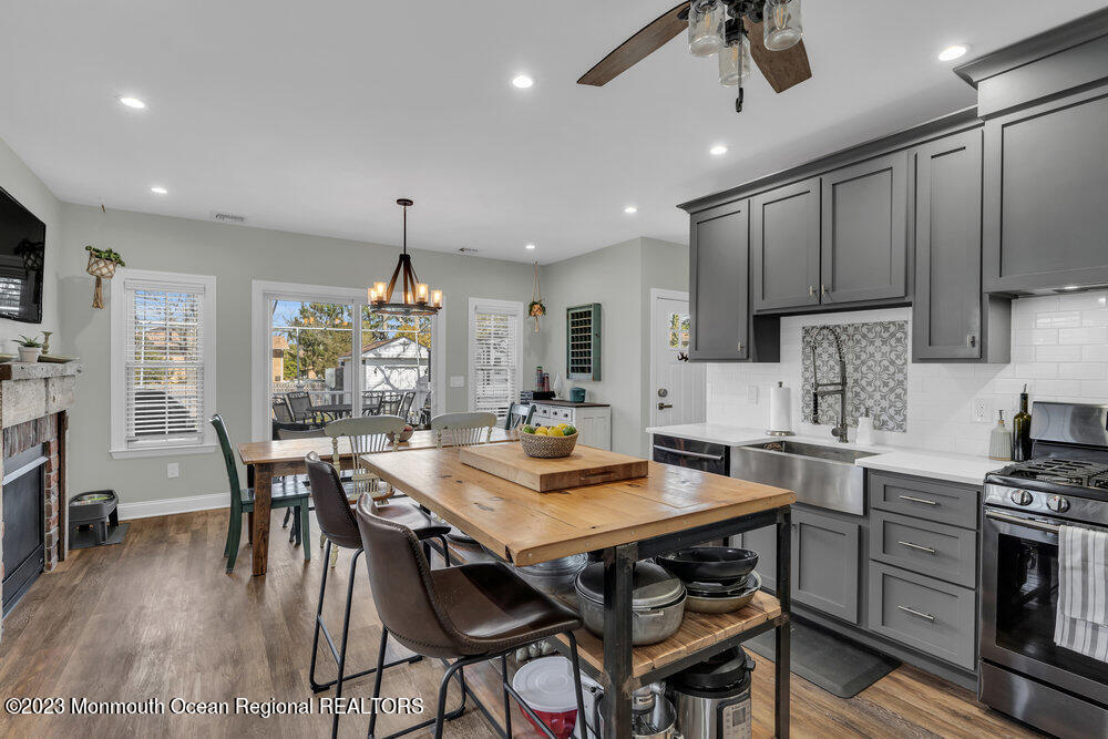 800 Wall Road Spring Lake Heights, NJ 07762 - Photo 8 of 41 a kitchen with stainless steel appliances granite countertop a stove a refrigerator a kitchen island a table and chairs