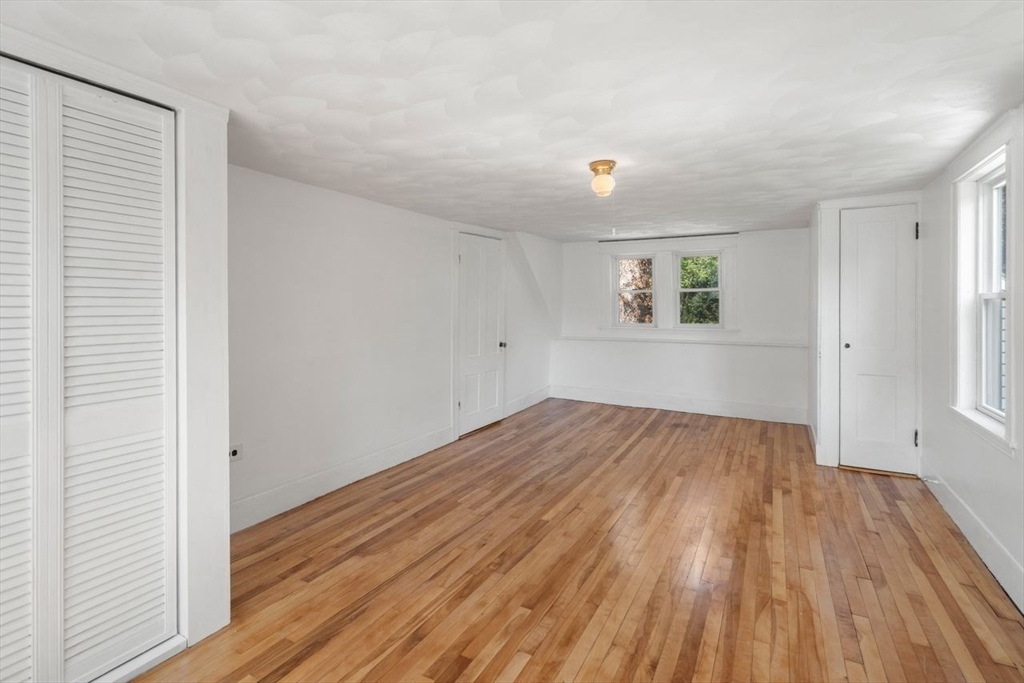 337 Boston Road Sutton, MA 01590 - Photo 19 of 38 an empty room with wooden floor and windows