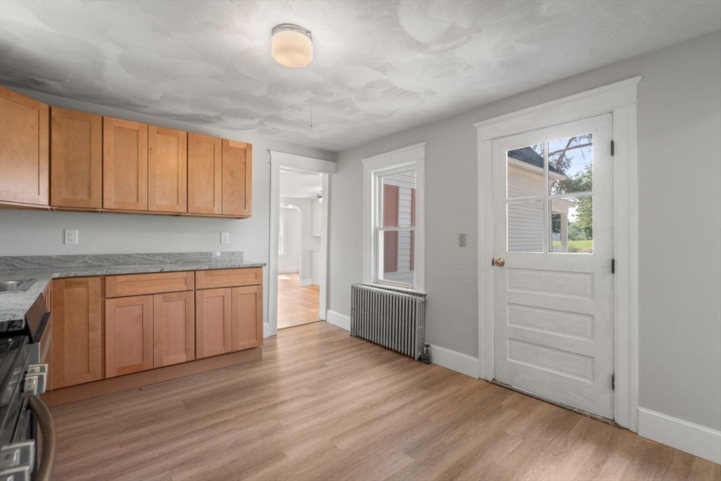 337 Boston Road Sutton, MA 01590 - Photo 9 of 38 an empty room with wooden floor and cabinet
