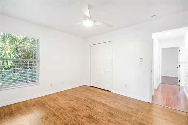 a bedroom with a large bed and a flat tv screen on dresser
