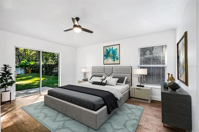 an empty room with wooden floor ceiling fan and window