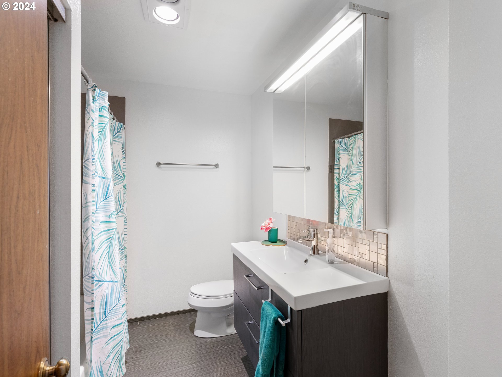 1727 Northeast Multnomah Street, Unit 14 Portland, OR 97232 - Photo 14 of 31 a bathroom with a sink toilet and mirror