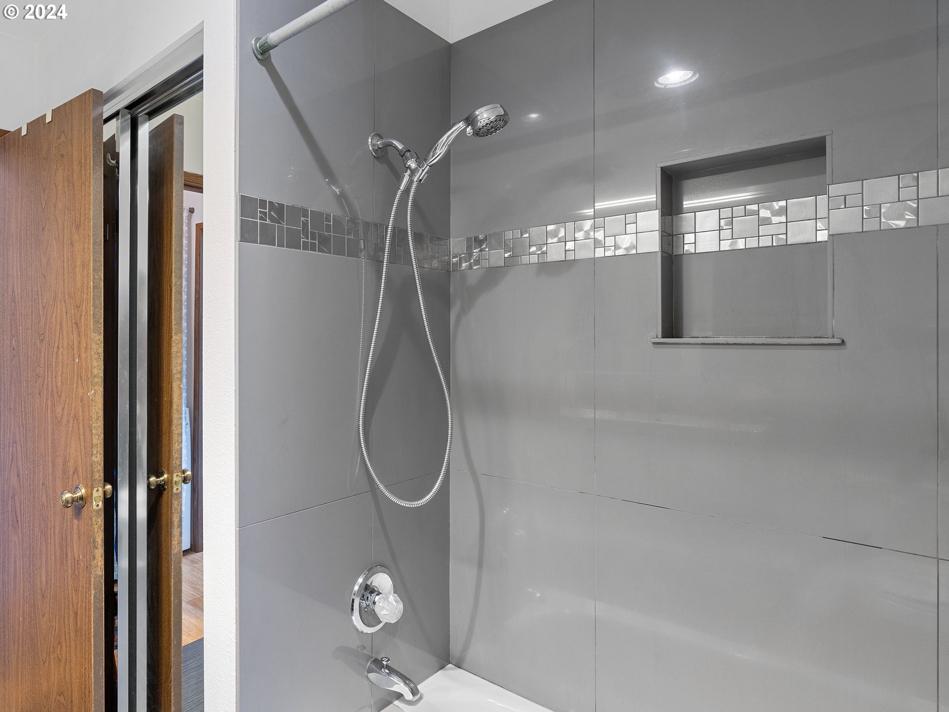 1727 Northeast Multnomah Street, Unit 14 Portland, OR 97232 - Photo 15 of 31 a bathroom with a shower a mirror and a glass door