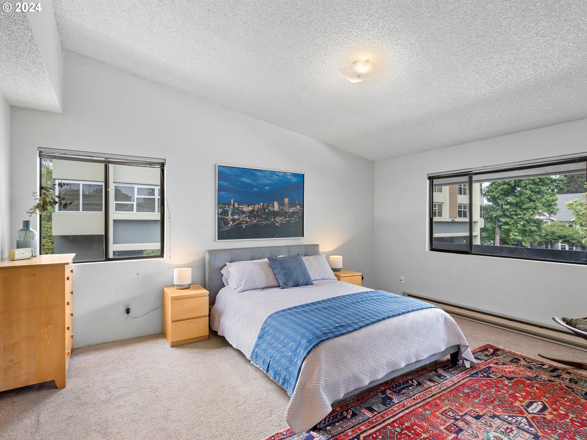 1727 Northeast Multnomah Street, Unit 14 Portland, OR 97232 - Photo 16 of 31 a bedroom with a bed and a window
