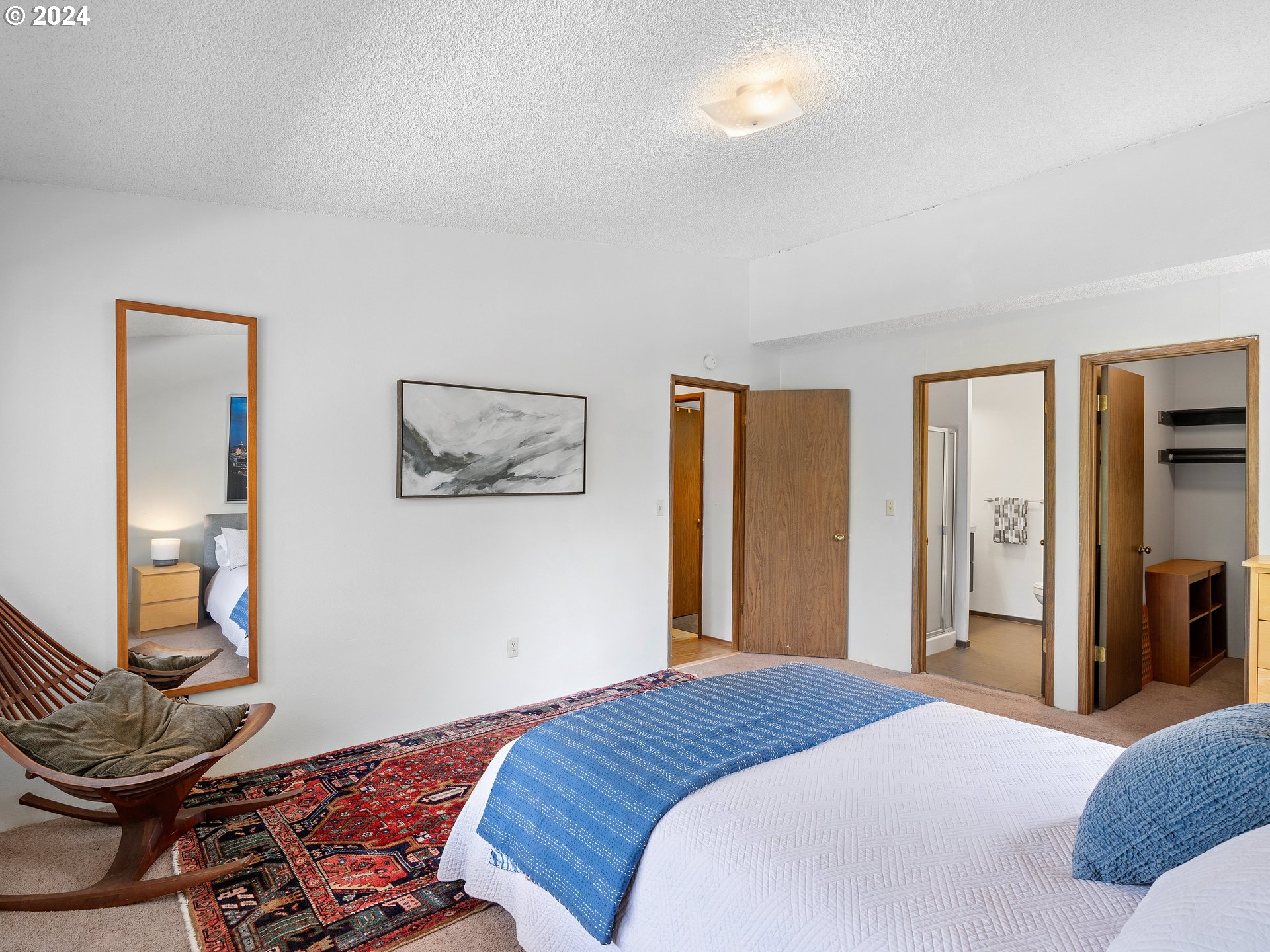 1727 Northeast Multnomah Street, Unit 14 Portland, OR 97232 - Photo 18 of 31 a bedroom with a bed and wooden floor