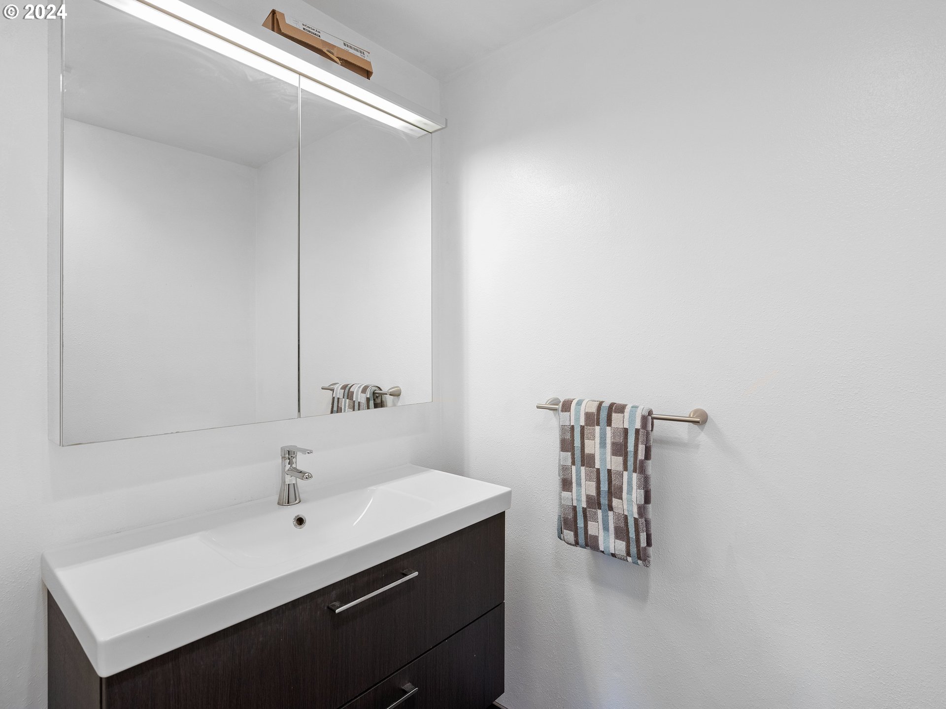 1727 Northeast Multnomah Street, Unit 14 Portland, OR 97232 - Photo 21 of 31 a bathroom with a sink and a mirror
