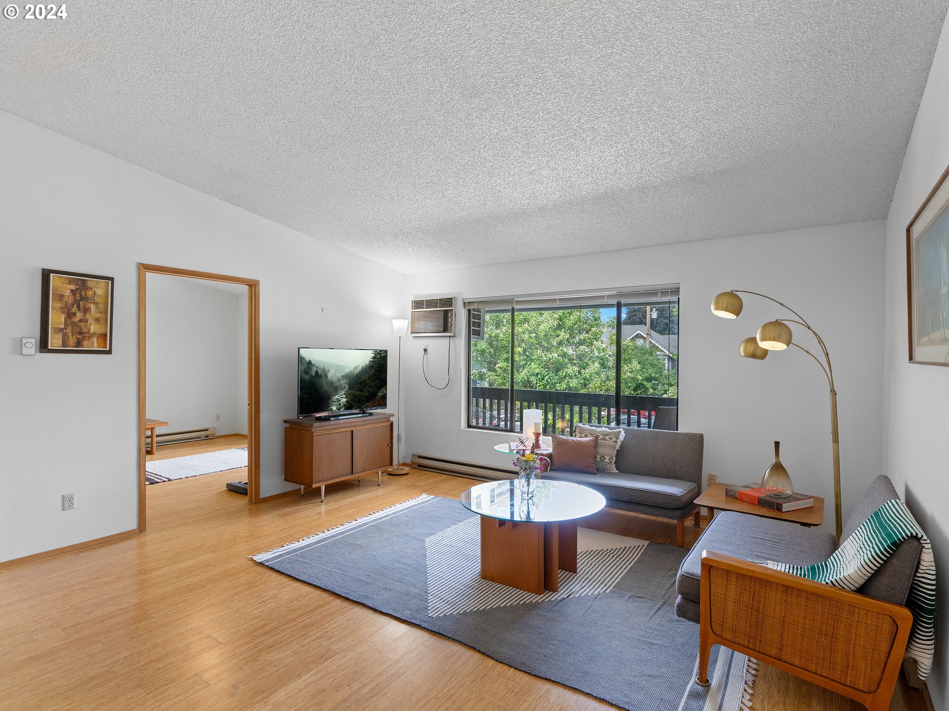 1727 Northeast Multnomah Street, Unit 14 Portland, OR 97232 - Photo 4 of 31 a living room with furniture and a large window